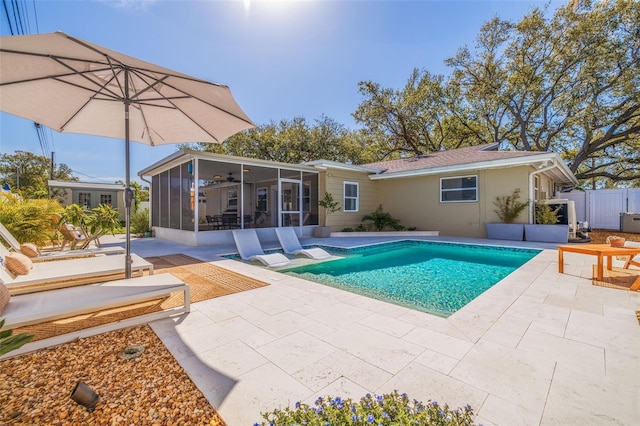 view of swimming pool with a gate, fence, a fenced in pool, a sunroom, and a patio area