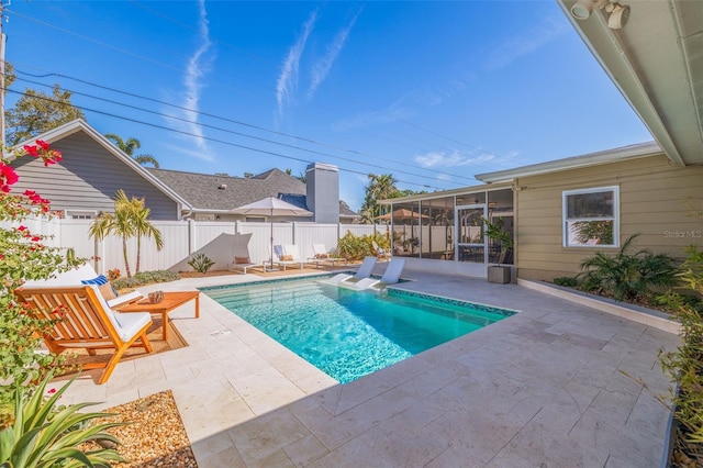 view of pool featuring a fenced in pool, a patio area, a fenced backyard, and a sunroom