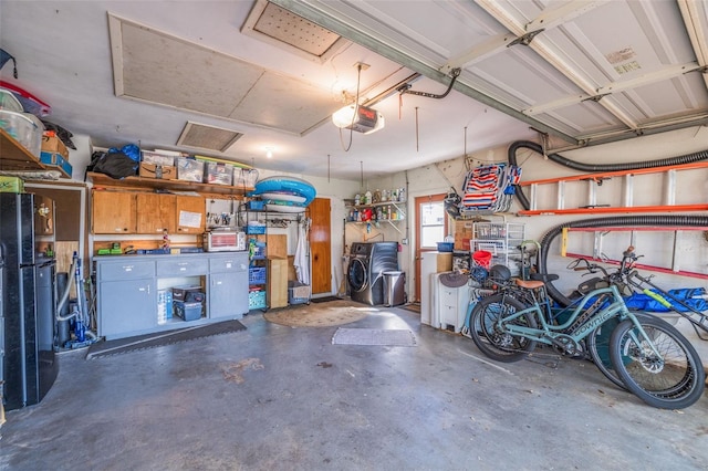 garage with freestanding refrigerator and a garage door opener