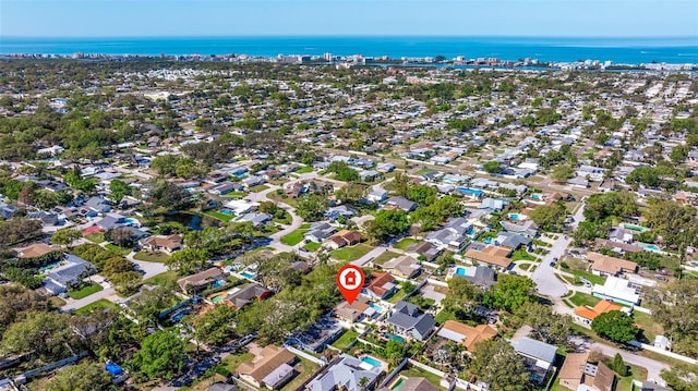 drone / aerial view featuring a water view and a residential view