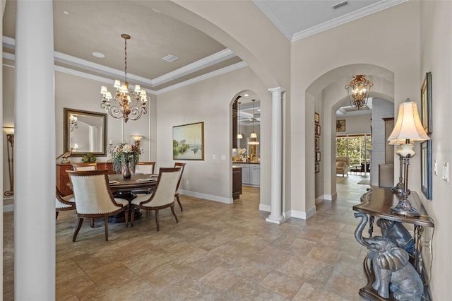 dining space with visible vents, arched walkways, baseboards, and crown molding