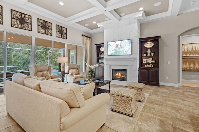 living area featuring baseboards, coffered ceiling, a high ceiling, beamed ceiling, and a large fireplace