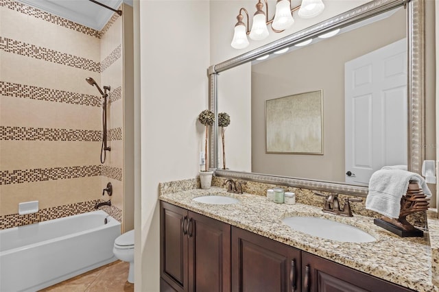 bathroom with double vanity, tile patterned floors, toilet, and a sink