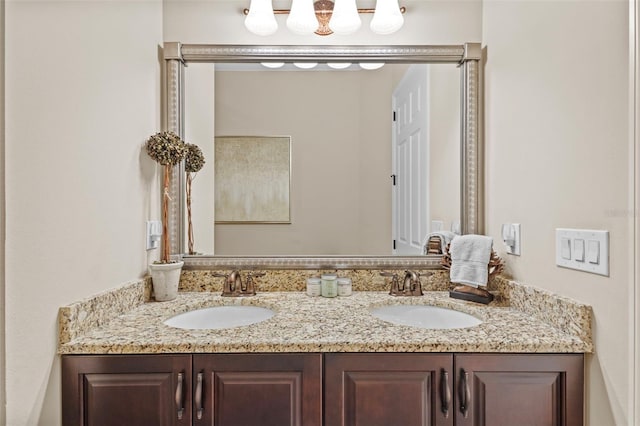 full bathroom with double vanity and a sink