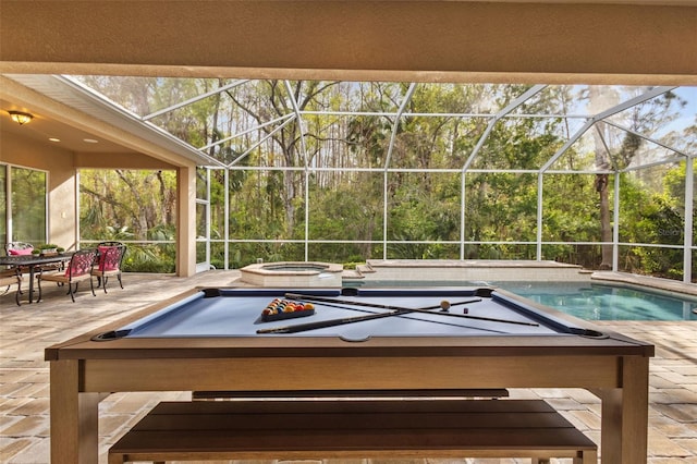 view of swimming pool featuring a lanai, an outdoor hot tub, and a patio area