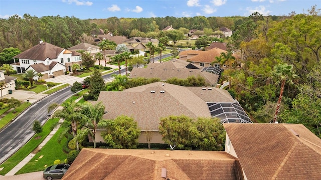 aerial view featuring a wooded view and a residential view