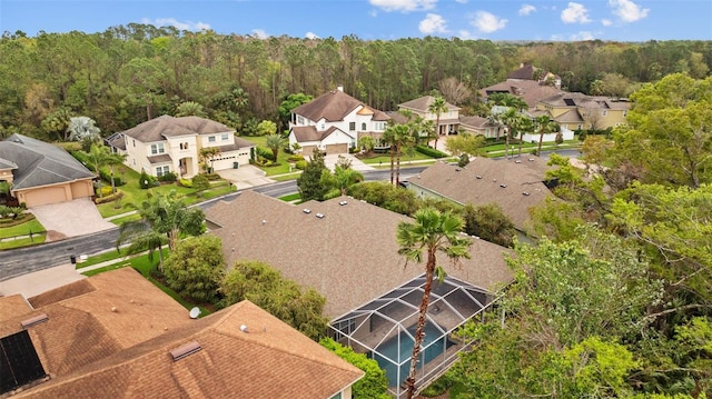 aerial view featuring a residential view and a wooded view