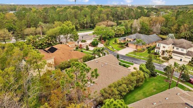 bird's eye view featuring a wooded view and a residential view