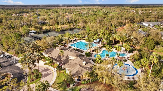 birds eye view of property featuring a view of trees