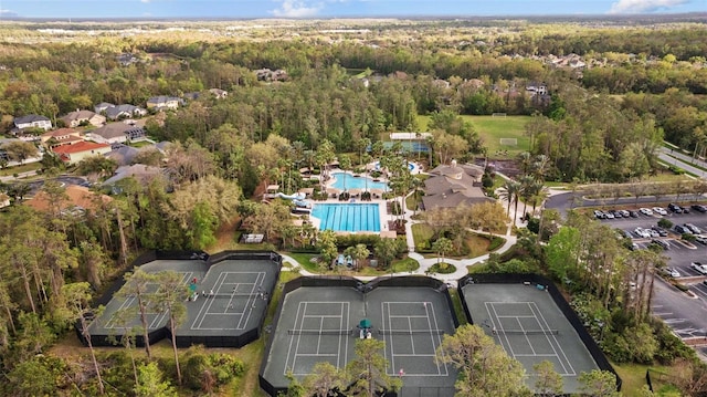 drone / aerial view with a wooded view