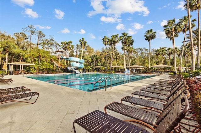 pool with a patio area, a gazebo, and a water slide