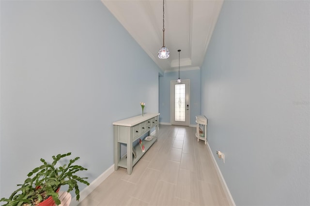 hall featuring vaulted ceiling, baseboards, and ornamental molding