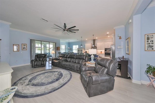 living area featuring visible vents, baseboards, a ceiling fan, and ornamental molding