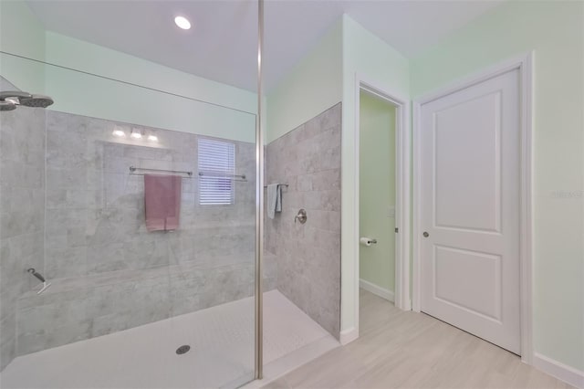 bathroom with baseboards and walk in shower