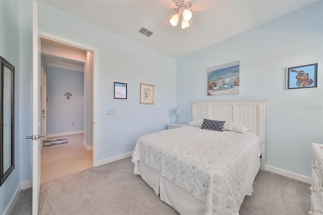 bedroom featuring a ceiling fan, light colored carpet, visible vents, and baseboards