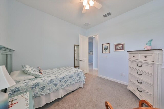 bedroom featuring visible vents, light carpet, baseboards, and a ceiling fan