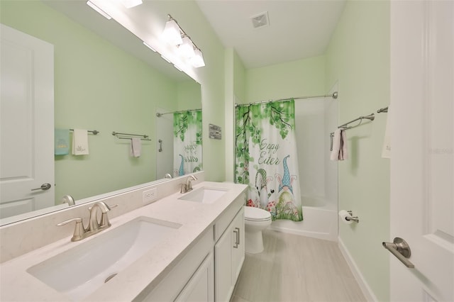 full bathroom featuring visible vents, toilet, shower / tub combo with curtain, and a sink