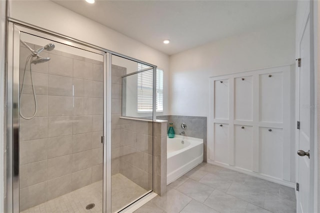 bathroom with tile patterned flooring, recessed lighting, a stall shower, and a bath