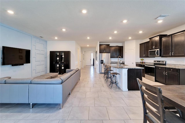 living area with light tile patterned flooring, visible vents, and recessed lighting