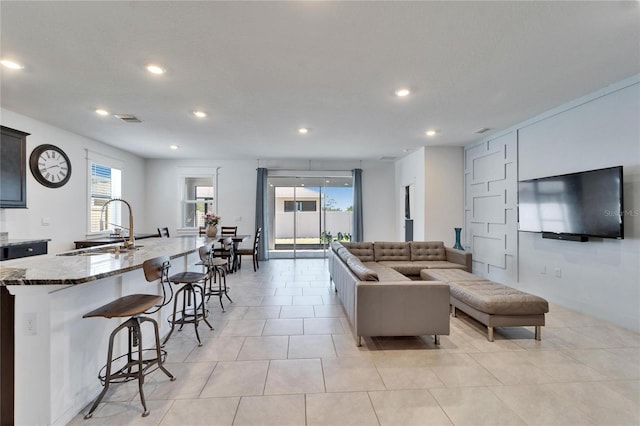 living area featuring visible vents, recessed lighting, and a healthy amount of sunlight