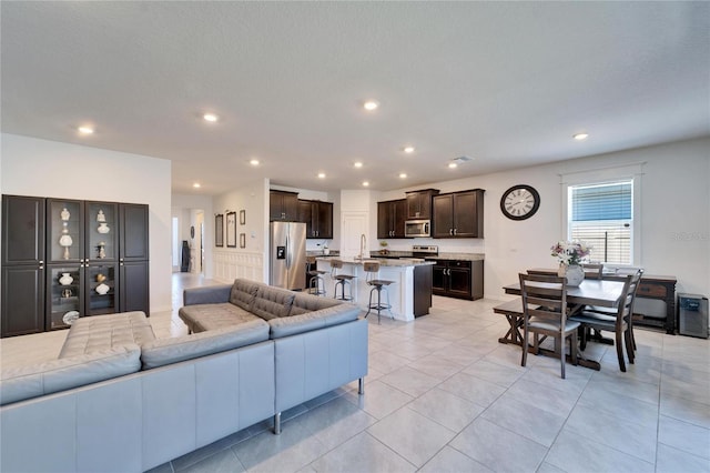 living room featuring light tile patterned floors and recessed lighting