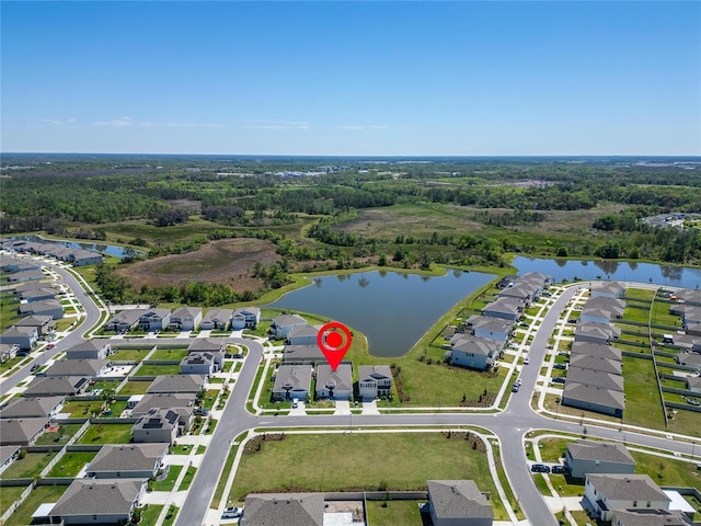 aerial view with a residential view, a water view, and a wooded view