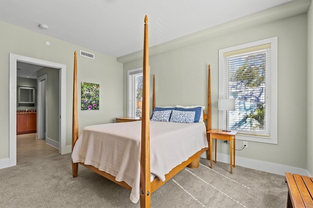 bedroom featuring visible vents, baseboards, and carpet