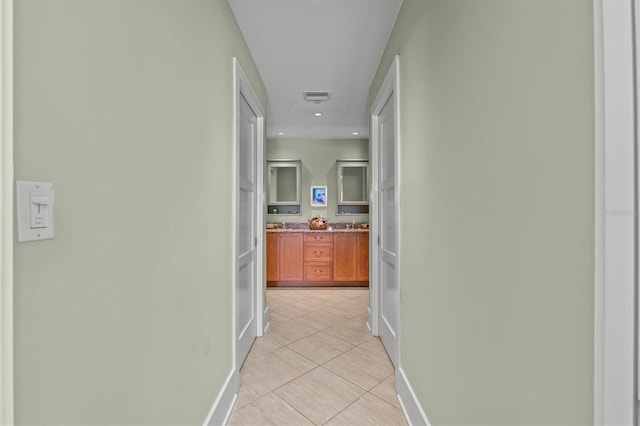 hall featuring recessed lighting, light tile patterned floors, baseboards, and visible vents