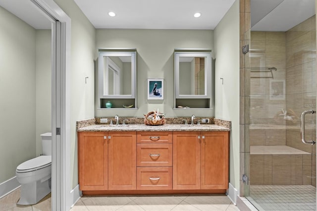 full bathroom featuring tile patterned floors, toilet, a shower stall, and a sink