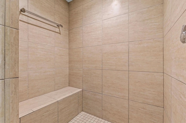 full bath with a tile shower