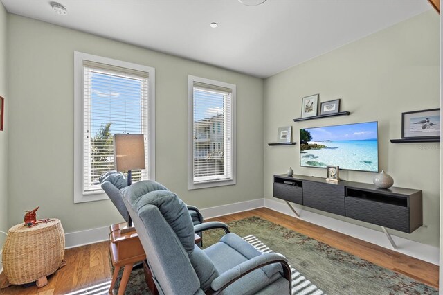 interior space with baseboards and wood finished floors