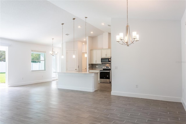 kitchen featuring a notable chandelier, appliances with stainless steel finishes, and open floor plan