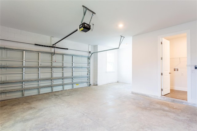 garage with a garage door opener and baseboards