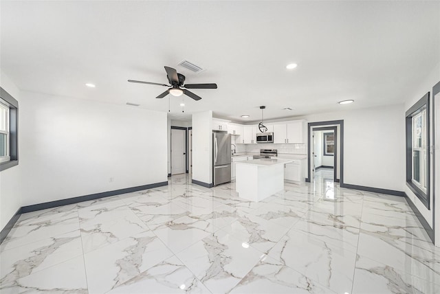 unfurnished living room featuring a ceiling fan, recessed lighting, baseboards, and visible vents