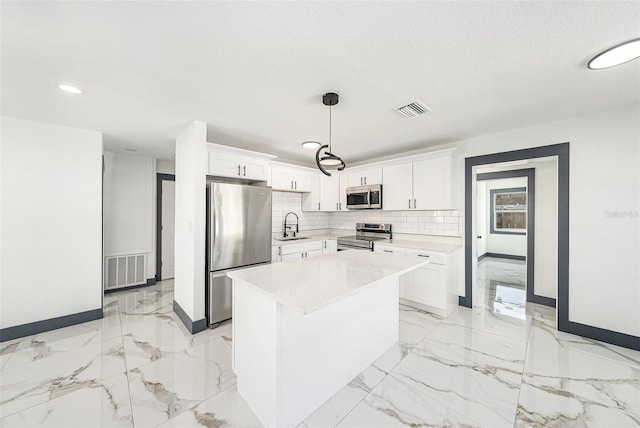 kitchen featuring visible vents, marble finish floor, appliances with stainless steel finishes, and a sink