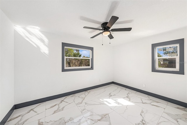 empty room featuring a healthy amount of sunlight and baseboards