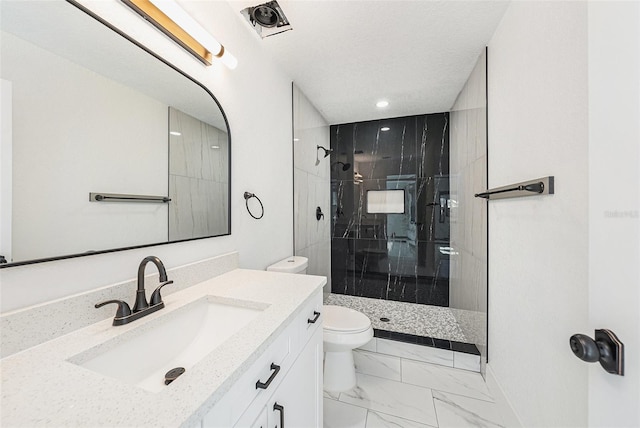 bathroom featuring a shower stall, toilet, marble finish floor, a textured ceiling, and vanity