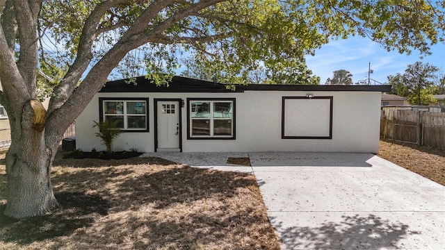 ranch-style home with a patio area, stucco siding, and fence