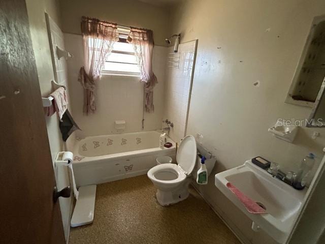 full bath with toilet, bathtub / shower combination, and a sink