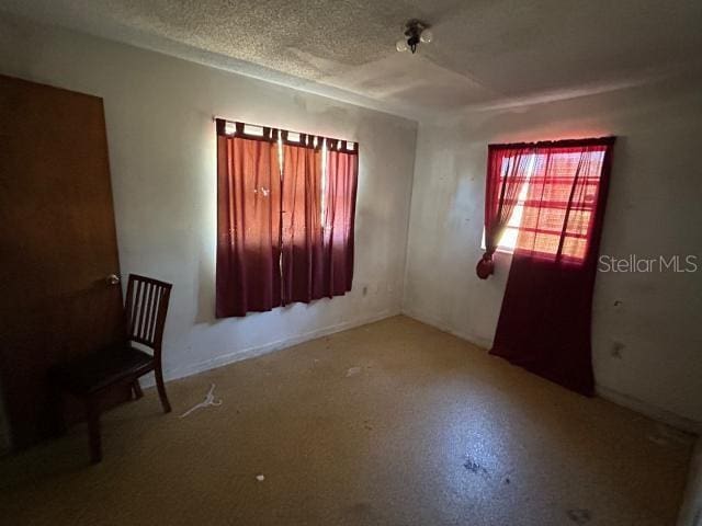 spare room with a textured ceiling