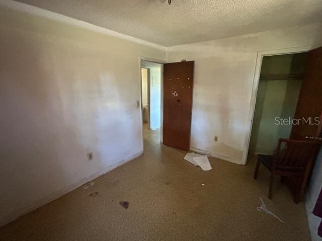 unfurnished bedroom with a textured ceiling