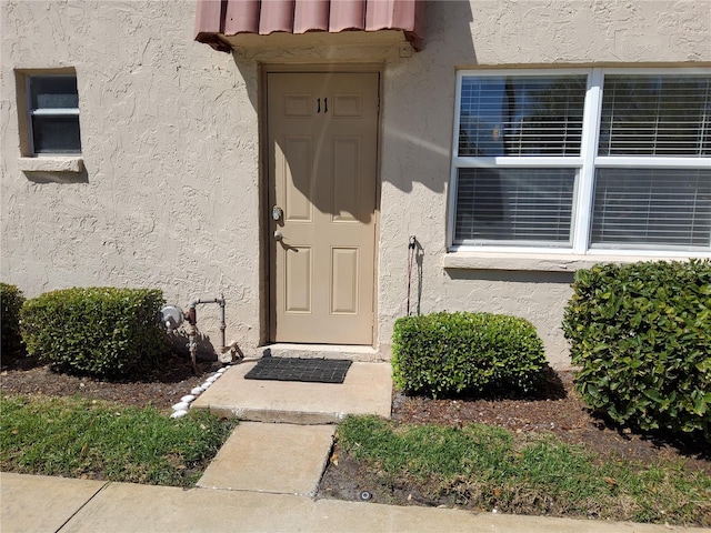 entrance to property with stucco siding