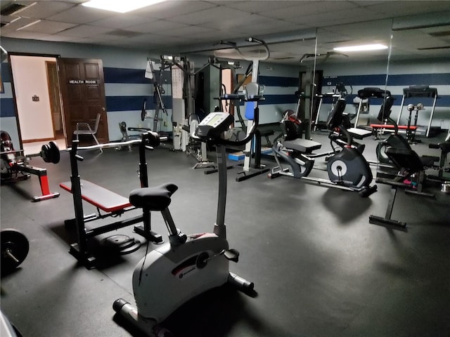 workout area featuring a paneled ceiling