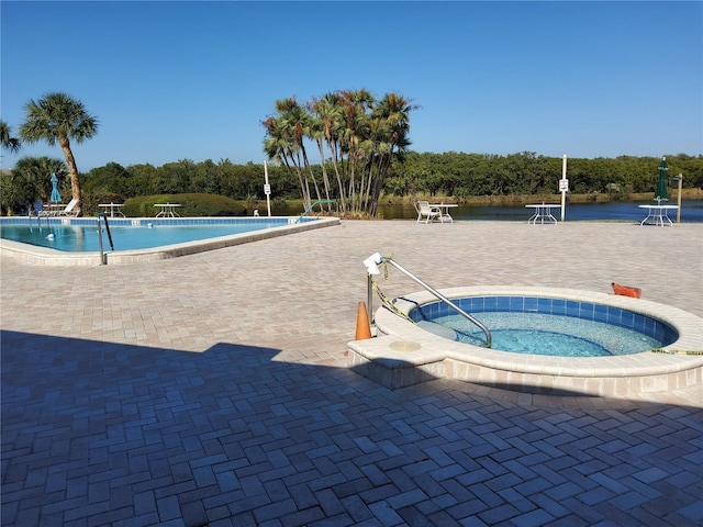 community pool featuring a patio and a hot tub