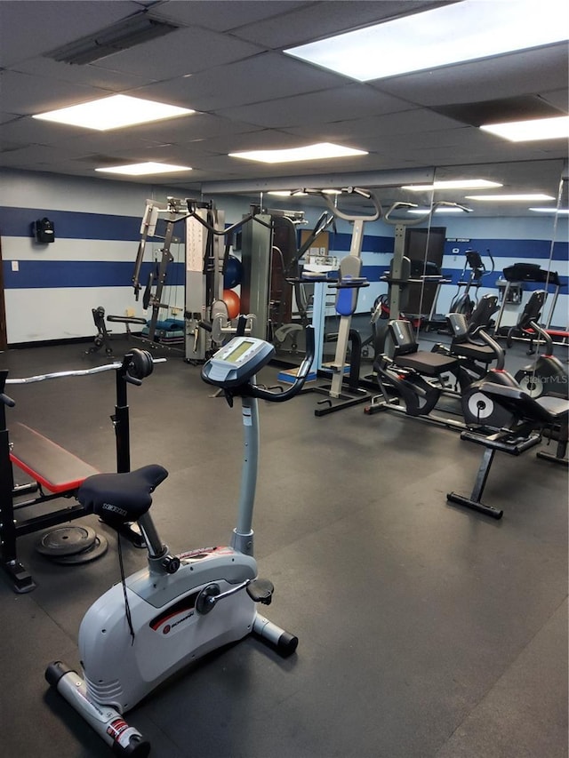 workout area featuring a paneled ceiling