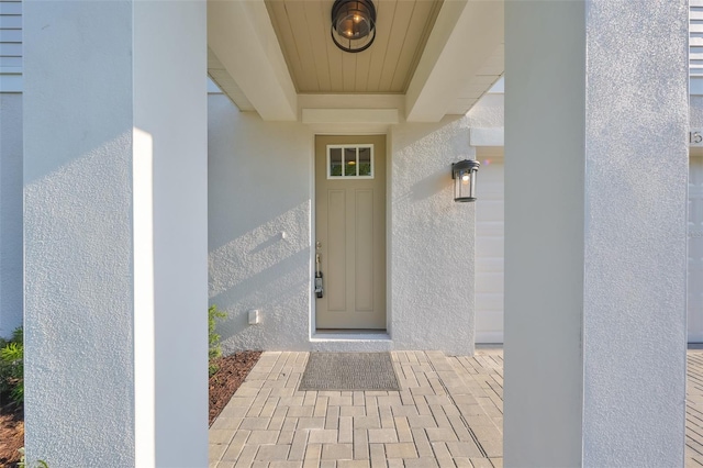 entrance to property with stucco siding