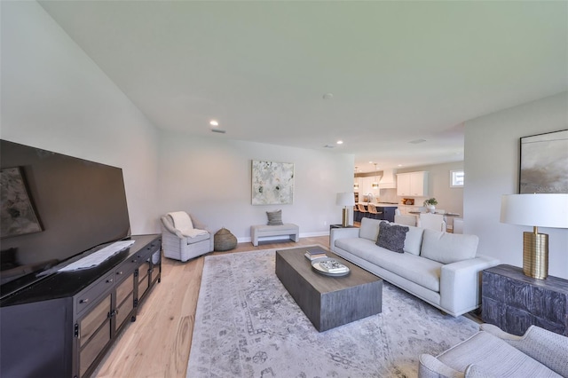 living room featuring light wood-style flooring and recessed lighting
