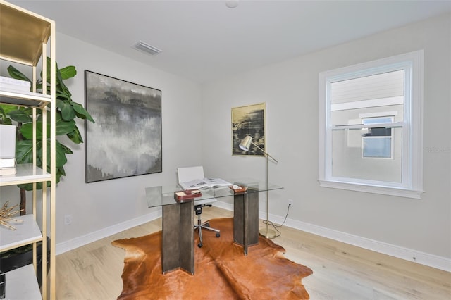 office featuring baseboards, wood finished floors, and visible vents