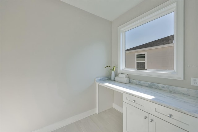 bathroom with baseboards and vanity