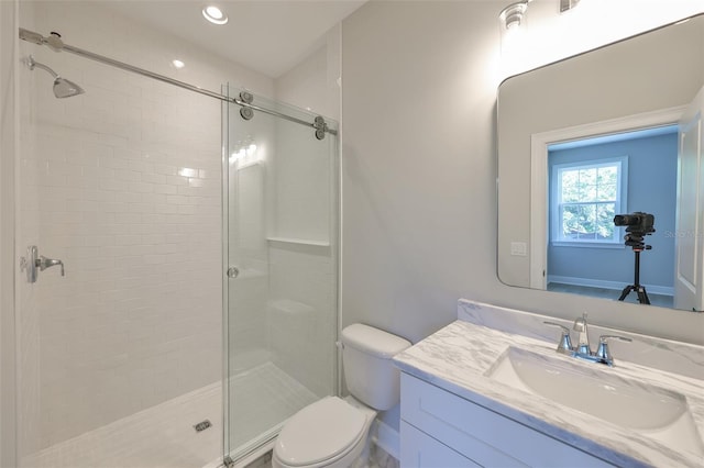 bathroom with toilet, vanity, recessed lighting, and a stall shower